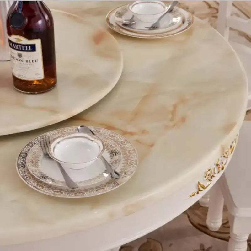 4 person gold dining table with elegant decorative plates and a bottle, perfect for modern living room settings.
