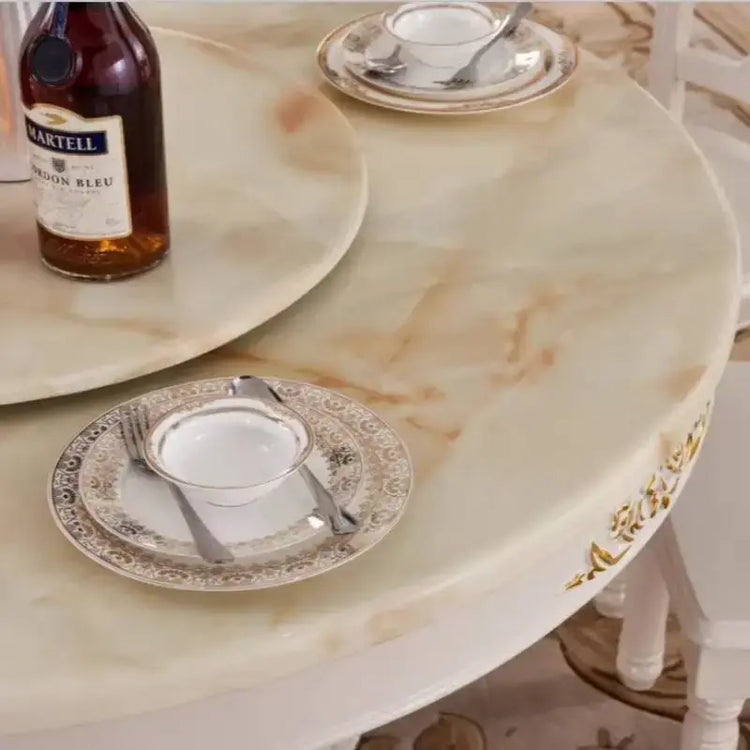 4 person gold dining table with elegant decorative plates and a bottle, perfect for modern living room settings.