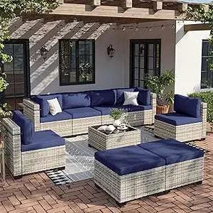 Outdoor patio furniture set with blue cushions on a patio area.