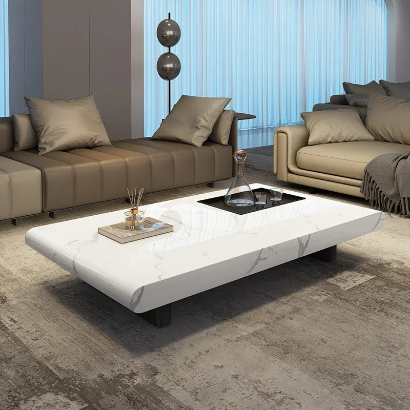 Modern living room with a white marble coffee table and beige sofas.