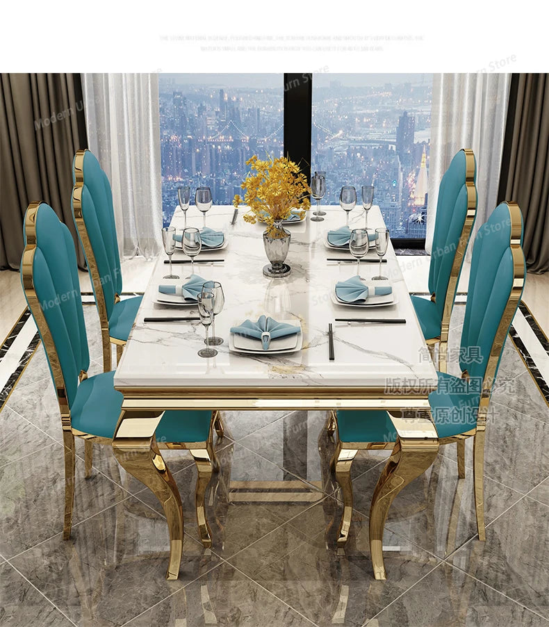 Dining table set with blue chairs and marble table in a room with city view.