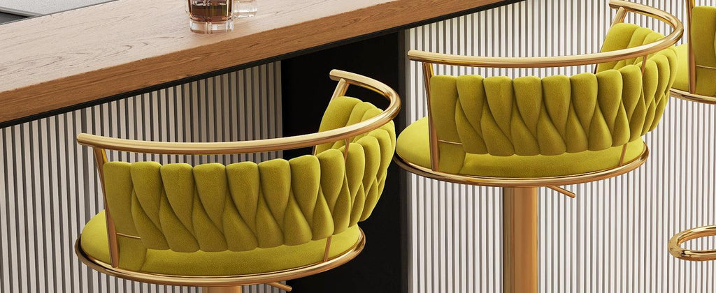 Green cushioned chairs with gold frames on a wooden floor.