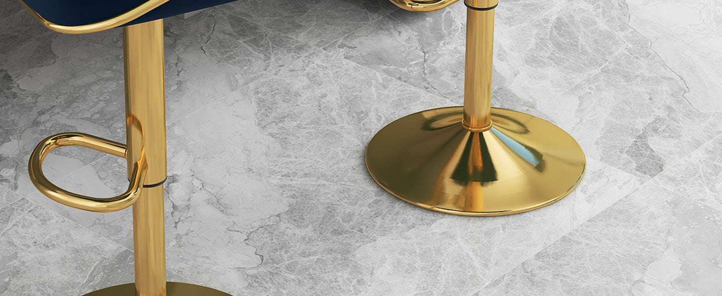 Gold bar stools with blue seats on a gray concrete floor.