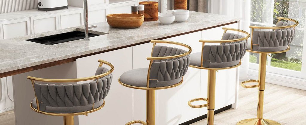 Modern kitchen with gray bar stools and a marble countertop.